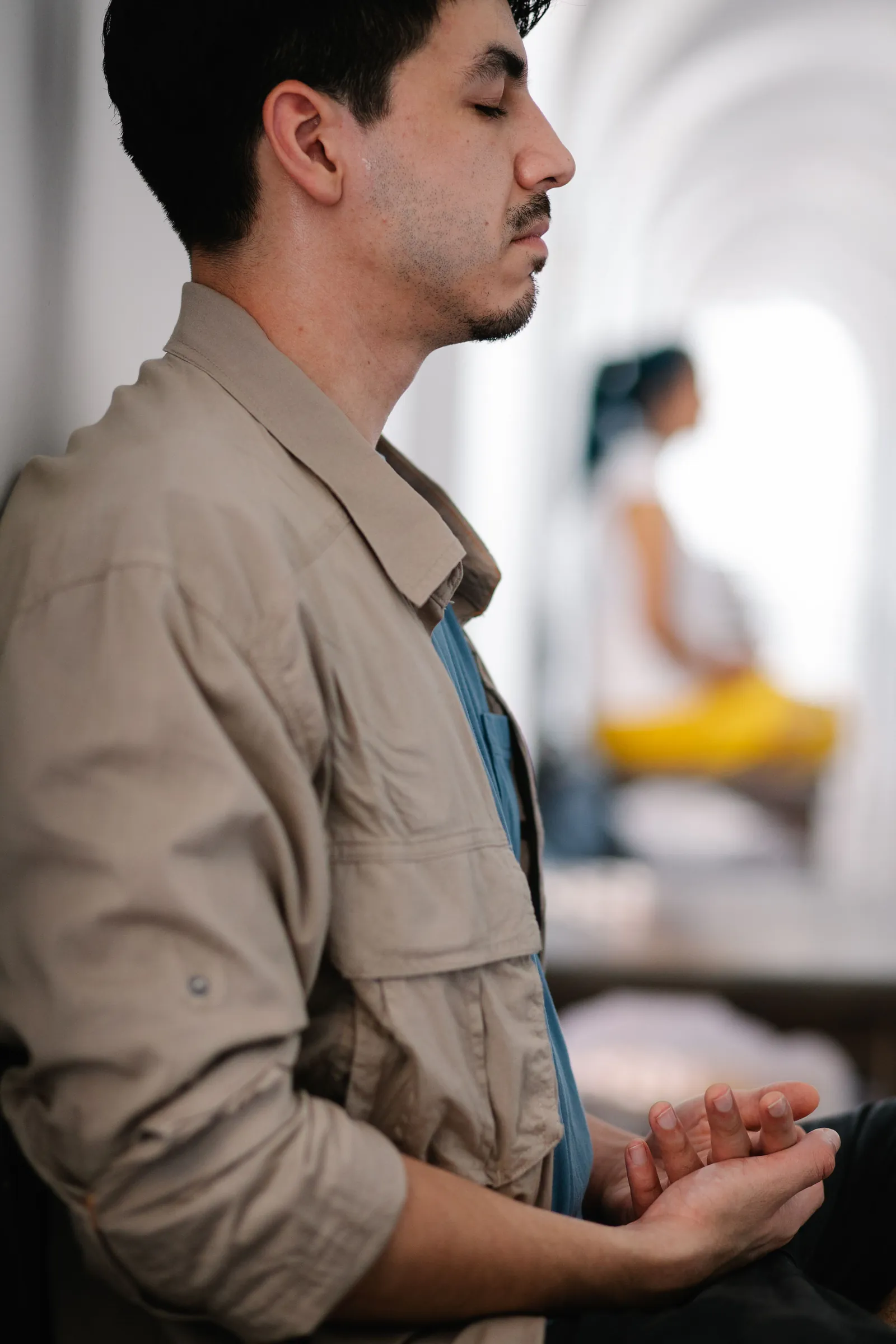 Man with eyes closed doing a calming breathing exercise