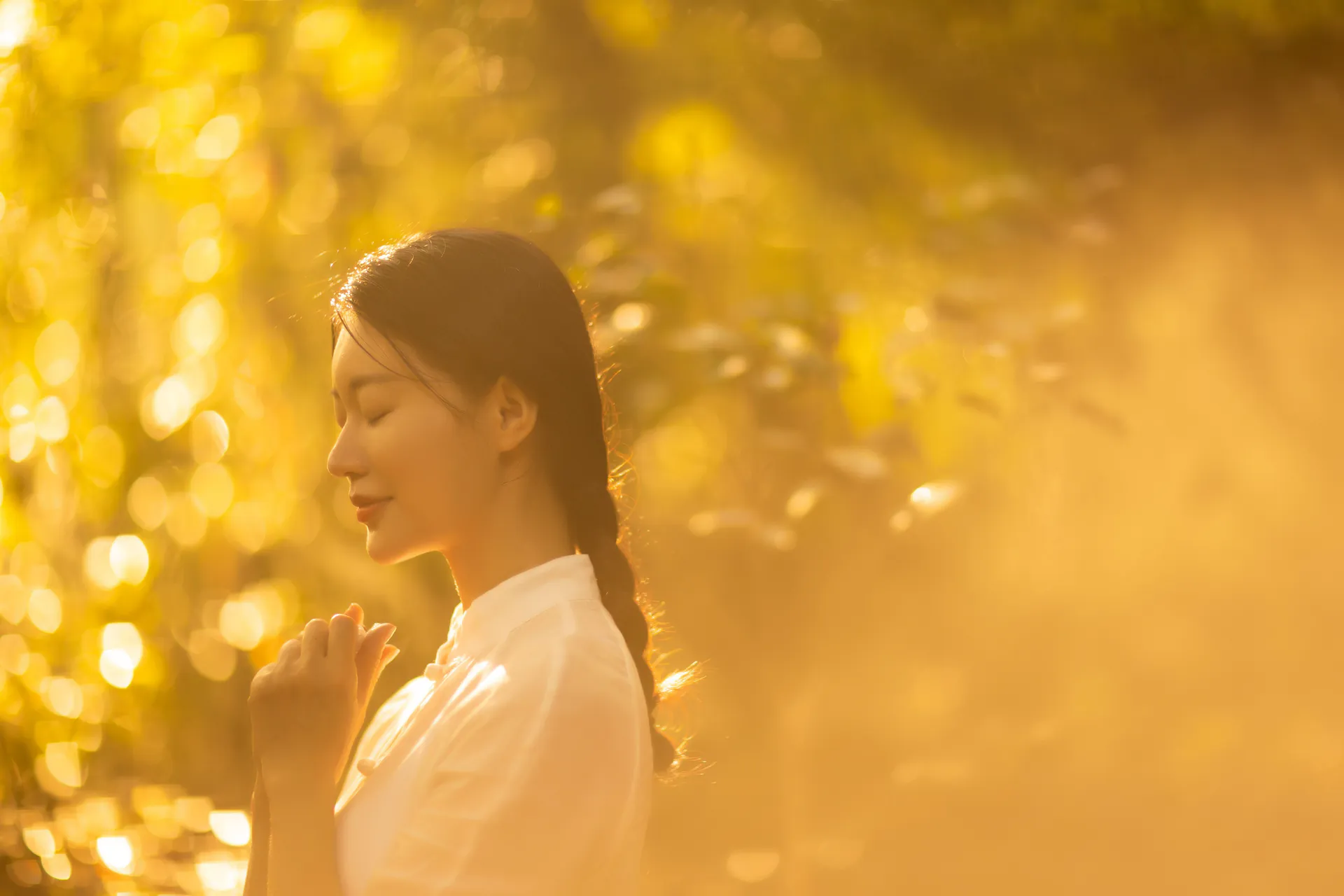 Woman smiling peacefully in warm golden light