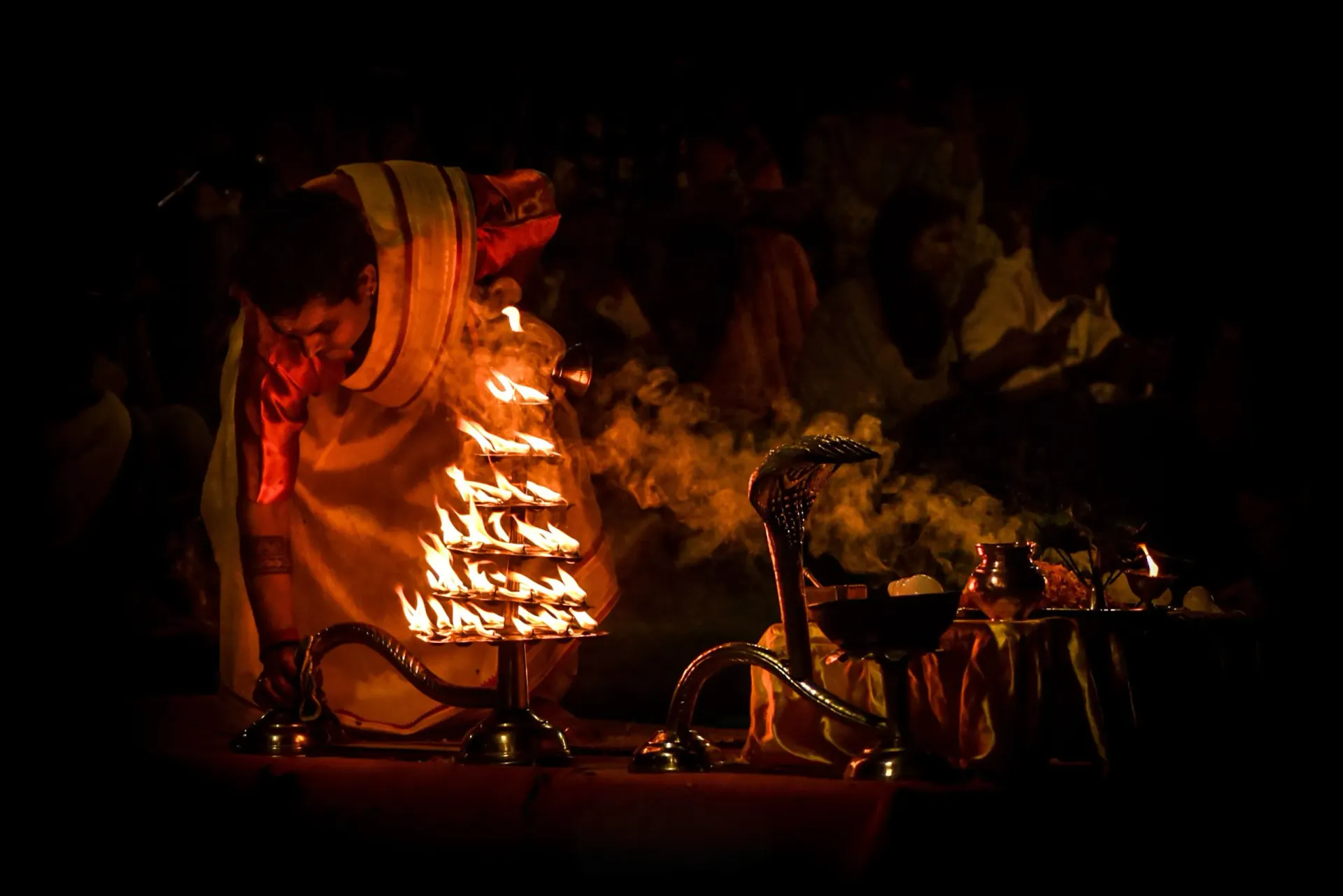 Devotee performing a fire aarti ritual at night
