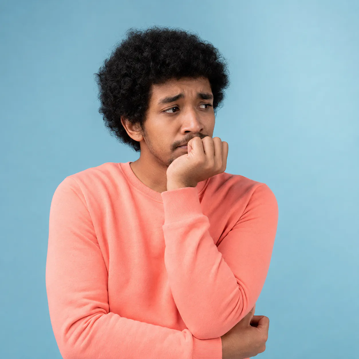 Worried young man biting his nails — anxiety counselling at Inner Hush
