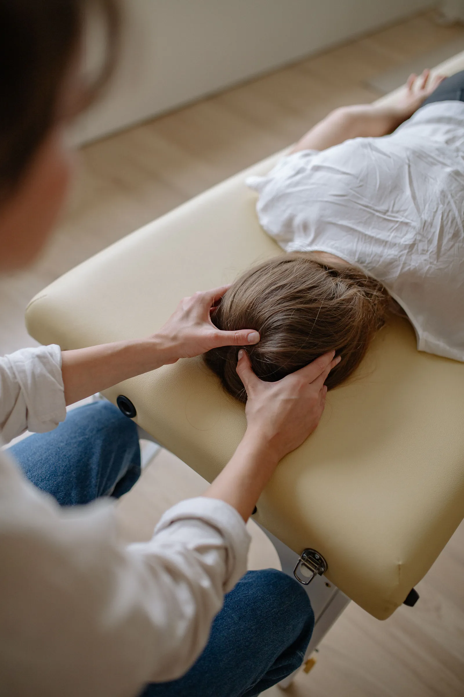 Therapist giving a calming head massage